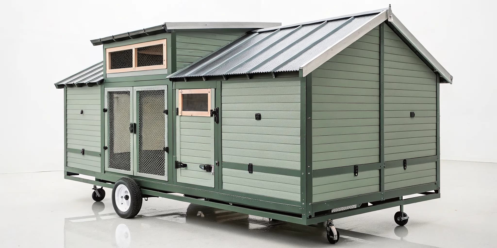 Predator-proof mobile chicken coop with a sturdy frame, secure latches, and hardware cloth.