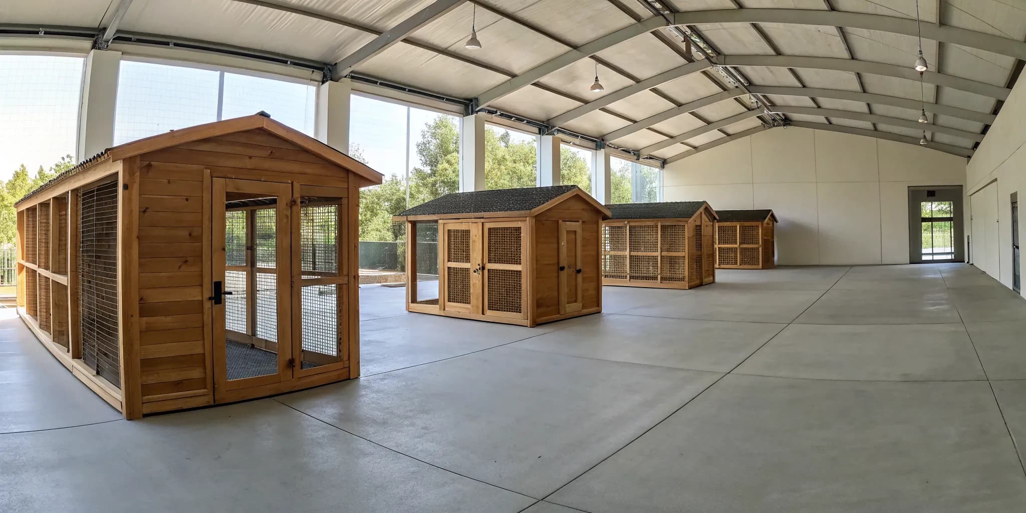 A collection of large walk-in chicken coops for sale.
